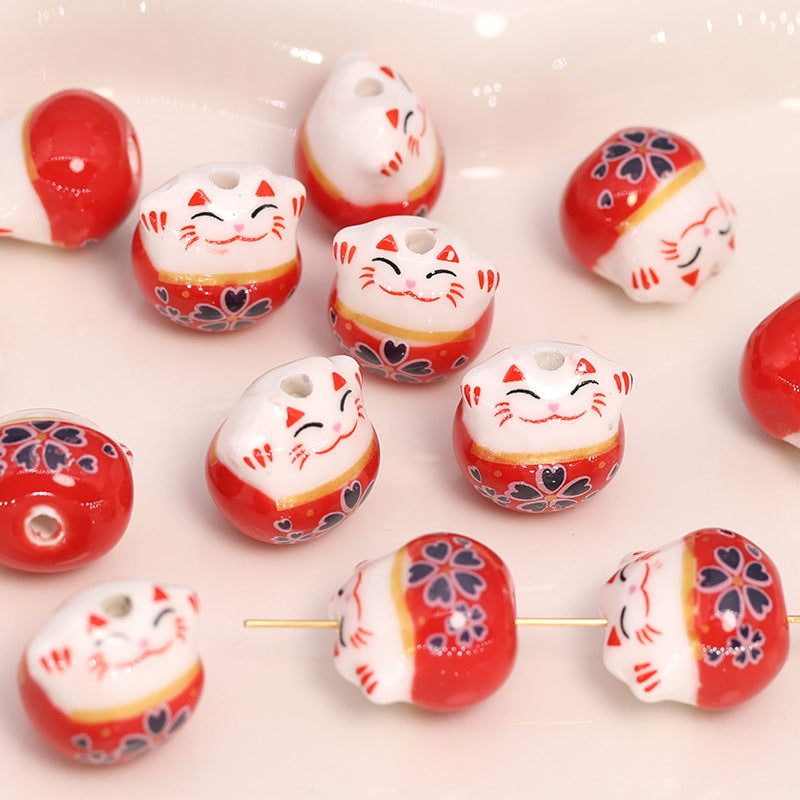 Achat Perle en porcelaine Maneki Neko rouge – 13 × 14 mm